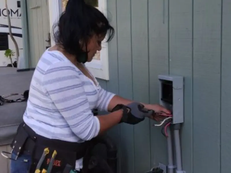 Licensed electrician wiring an exterior subpanel in Ecorse